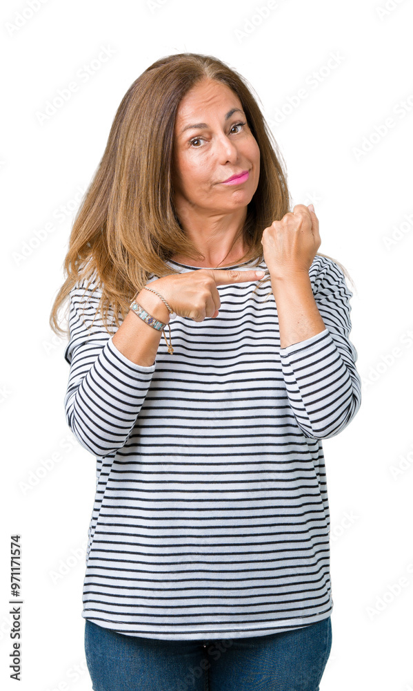 Beautiful middle age woman wearing stripes sweater over isolated background In hurry pointing to watch time, impatience, upset and angry for deadline delay Beautiful middle age woman wearing stripes sweater over isolated background In hurry pointing to watch time, impatience, upset and angry for deadline delay