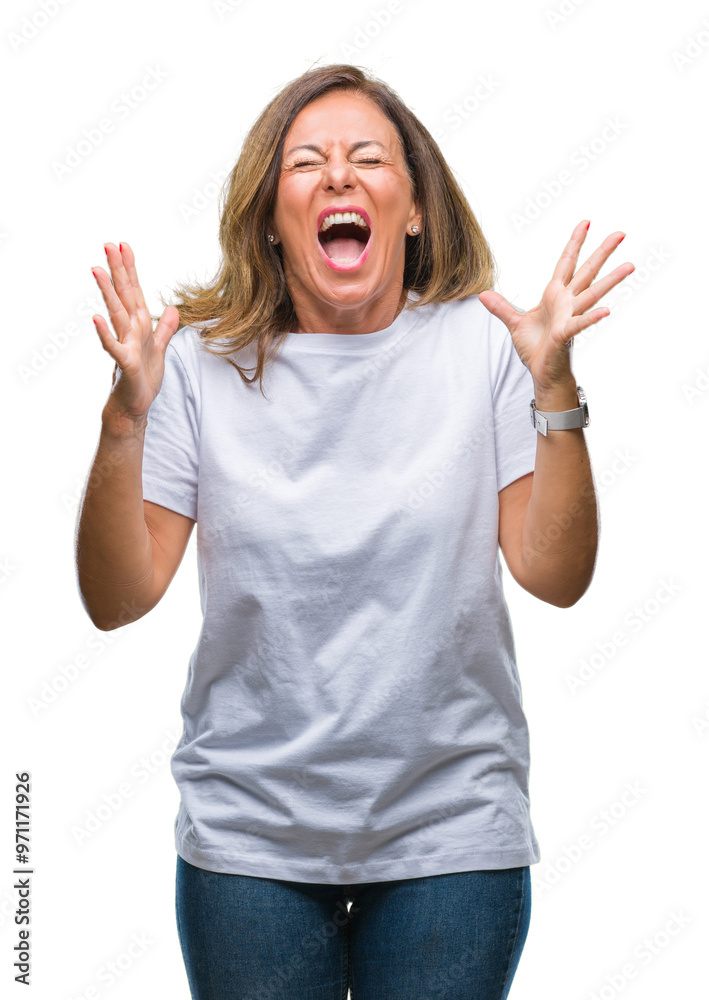 Middle age senior hispanic woman over isolated background celebrating mad and crazy for success with arms raised and closed eyes screaming excited. Winner concept