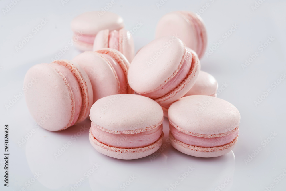 Fototapeta premium Pink colored. Bunch of macarons on the white surface