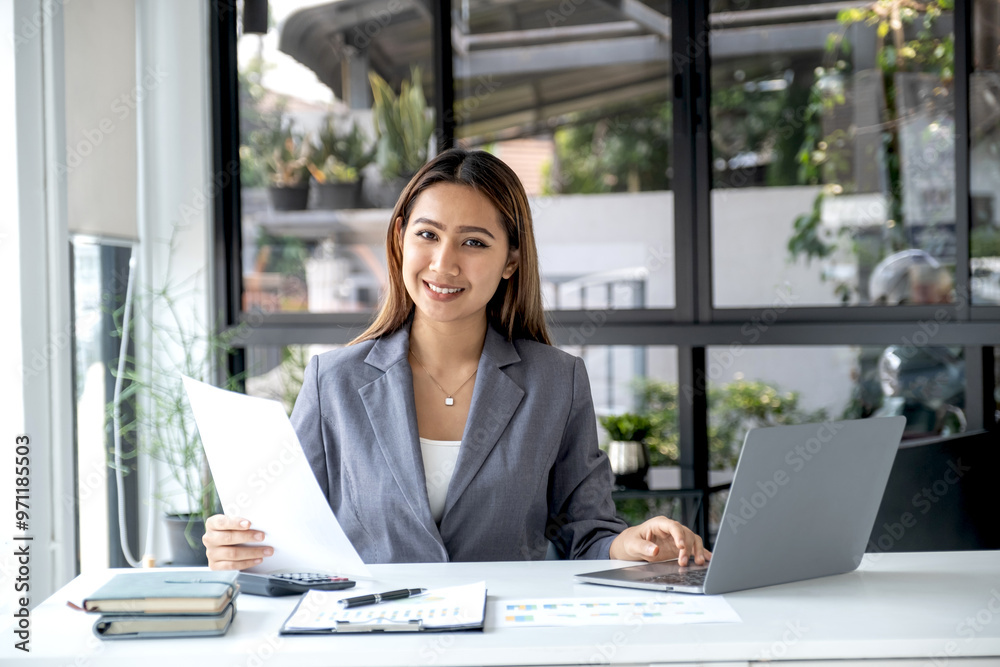 Businesswomen bookkeeper use laptop analysis the graph for Setting challenging business goals and ready to achieve target at home office Businesswomen bookkeeper use laptop analysis the graph for Setting challenging business goals and ready to achieve target at home office