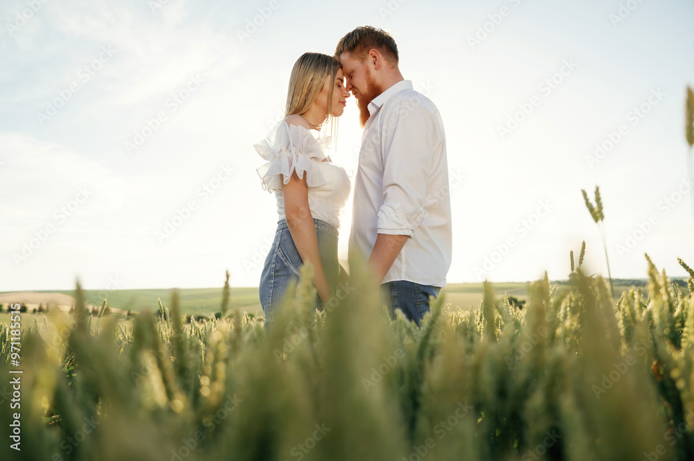 Lovely couple are on the green agricultural field together Lovely couple are on the green agricultural field together
