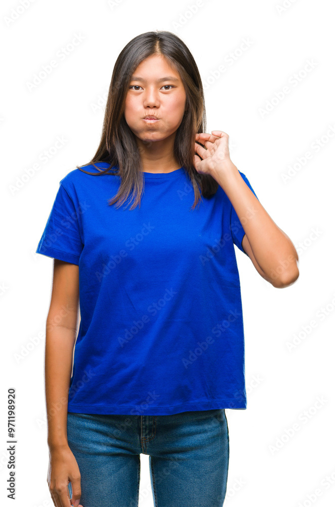 Young asian woman over isolated background puffing cheeks with funny face. Mouth inflated with air, crazy expression. Young asian woman over isolated background puffing cheeks with funny face. Mouth inflated with air, crazy expression.