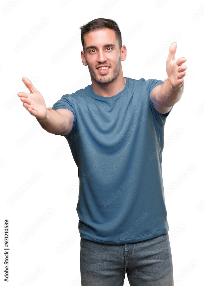 Handsome young casual man looking at the camera smiling with open arms for hug. Cheerful expression embracing happiness. Handsome young casual man looking at the camera smiling with open arms for hug. Cheerful expression embracing happiness.