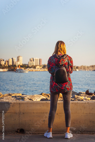 woman takes a photo on her smartphone the embankment in Istanbul in the Kadikoy photo