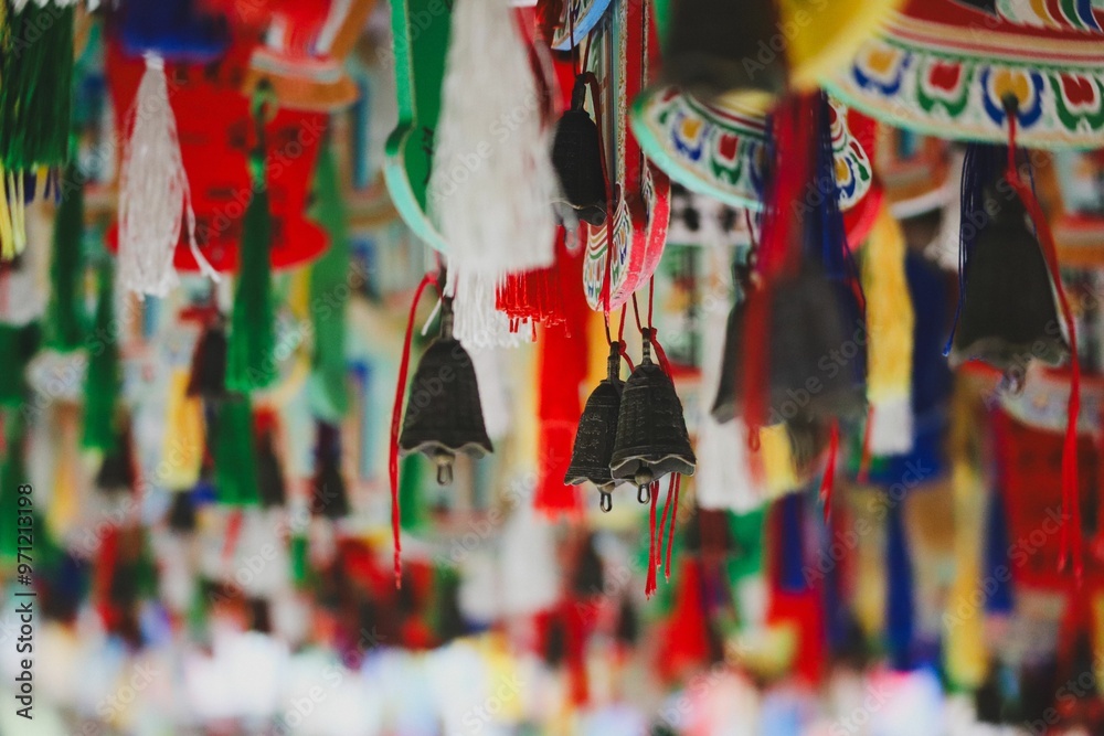 Fototapeta premium Colorful hanging decorations and bells in an Asian market or temple.