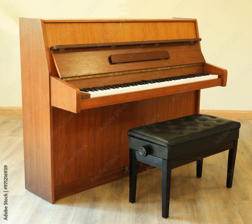 Upright piano with seat. Musical instruments concept Upright piano with seat. Musical instruments concept