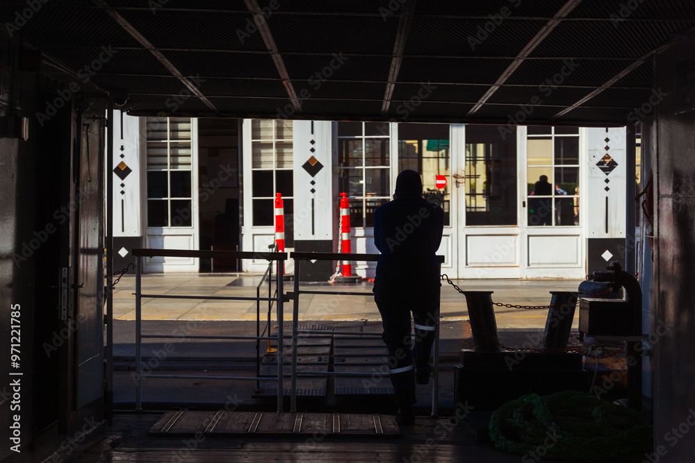 A man on a ferry while docking at a pier in Istanbul A man on a ferry while docking at a pier in Istanbul