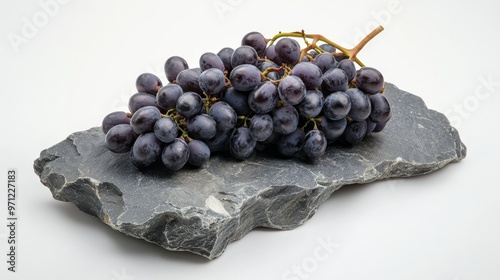 Fresh black grapes on gray stone, white background. photo