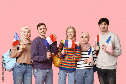 Group of students with French flags on pink background