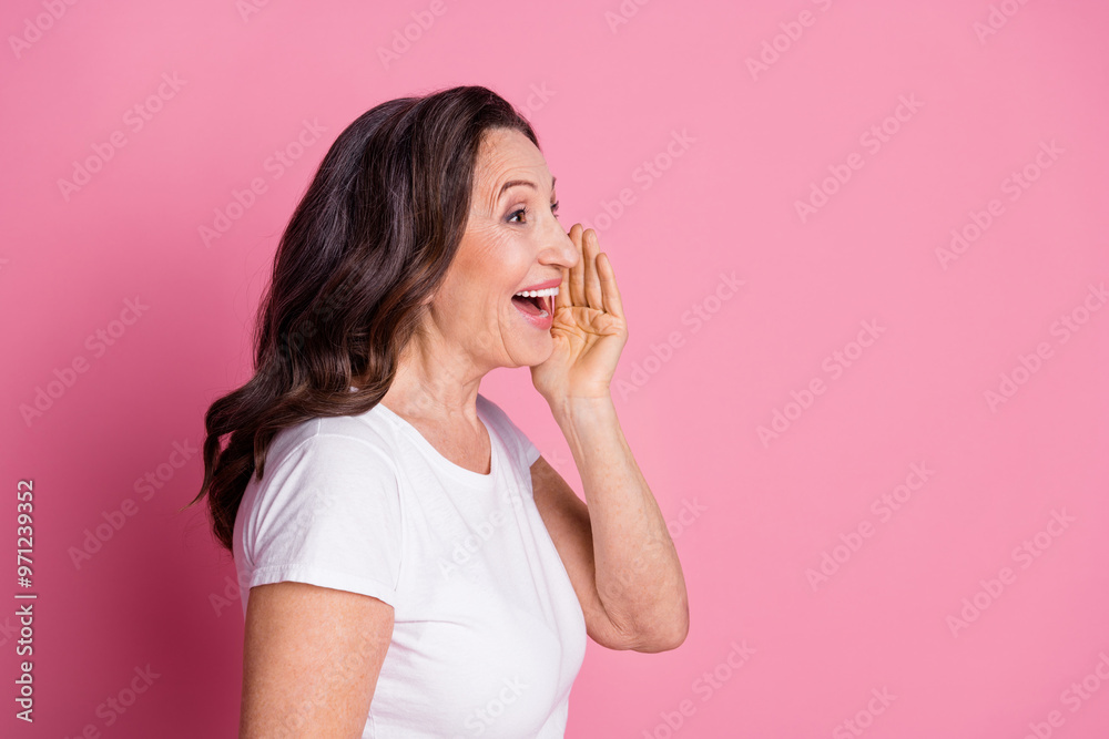 Photo portrait of elegant beautiful mature age woman with wavy hairstyle happy saying information isolated on pink color background Photo portrait of elegant beautiful mature age woman with wavy hairstyle happy saying information isolated on pink color background