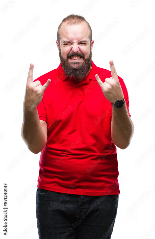 Young caucasian hipster man wearing red shirt over isolated background shouting with crazy expression doing rock symbol with hands up. Music star. Heavy concept. Young caucasian hipster man wearing red shirt over isolated background shouting with crazy expression doing rock symbol with hands up. Music star. Heavy concept.