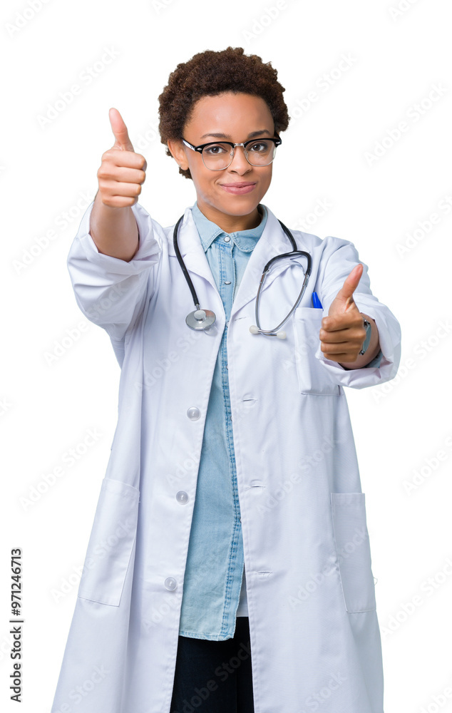 Young african american doctor woman wearing medical coat over isolated background approving doing positive gesture with hand, thumbs up smiling and happy for success. Looking at the camera.
