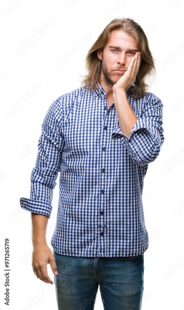 Young handsome man with long hair over isolated background thinking looking tired and bored with depression problems with crossed arms.