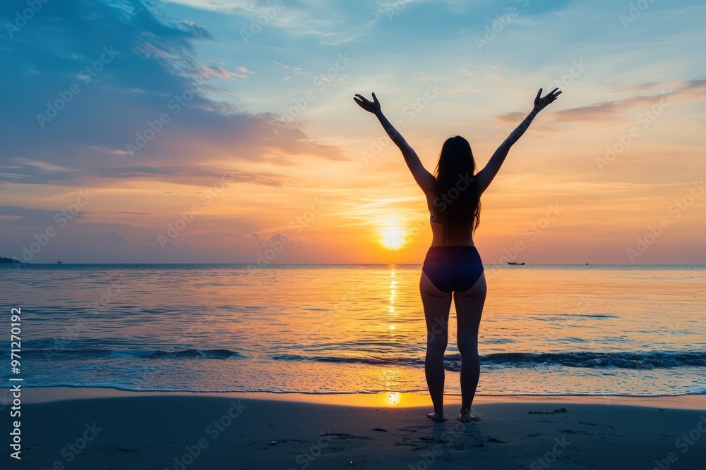 Silhouette of a joyful woman with arms raised at sunset on the beach, embodying freedom and success. Silhouette of a joyful woman with arms raised at sunset on the beach, embodying freedom and success.
