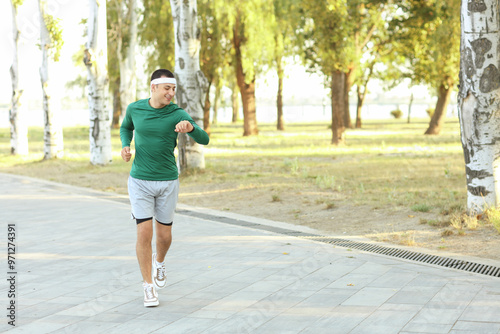 Sporty young man looking at...