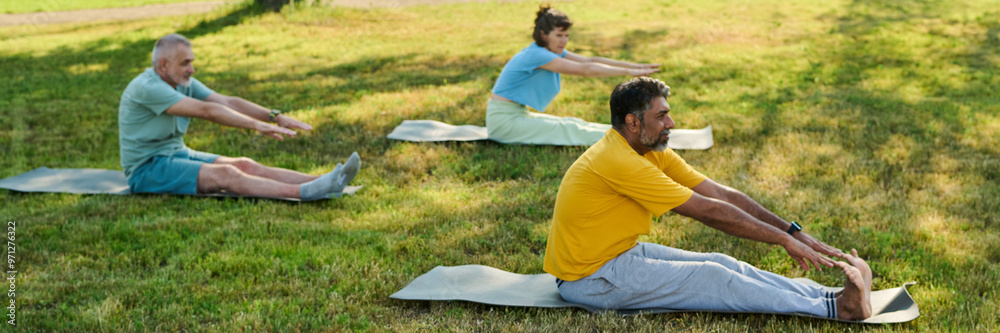 Banner of active elderly intercultural men and woman doing stretching exercise on green lawn on sunny summer day Banner of active elderly intercultural men and woman doing stretching exercise on green lawn on sunny summer day