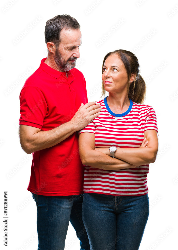 Middle age hispanic couple in love over isolated background with serious expression on face. Simple and natural looking at the camera. Middle age hispanic couple in love over isolated background with serious expression on face. Simple and natural looking at the camera.