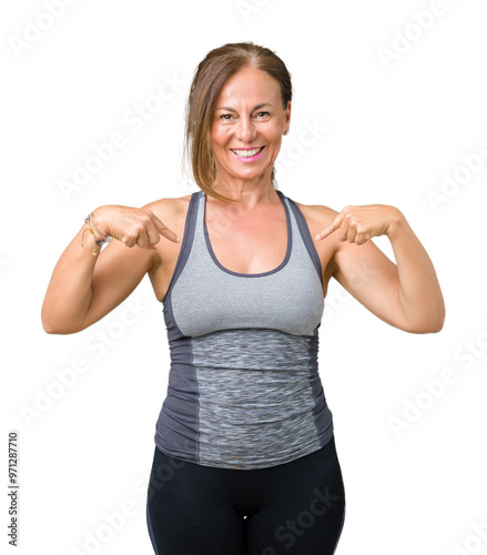 Beautiful middle age woman wearing sport clothes over isolated background looking confident with smile on face, pointing oneself with fingers proud and happy.