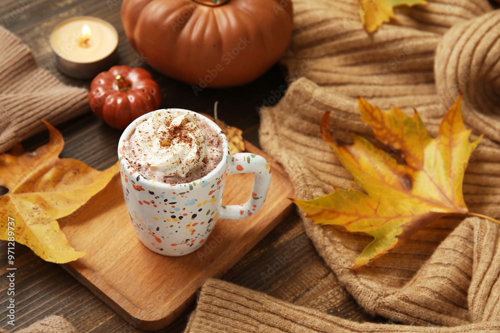Autumn composition with cup of cocoa, sweater and decorative pumpkins on wooden background Autumn composition with cup of cocoa, sweater and decorative pumpkins on wooden background