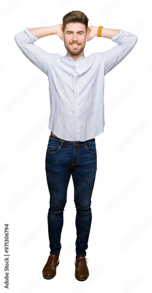 Young handsome man Relaxing and stretching with arms and hands behind head and neck, smiling happy Young handsome man Relaxing and stretching with arms and hands behind head and neck, smiling happy
