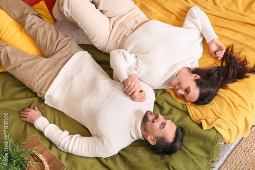 Young couple lying in bedro...
