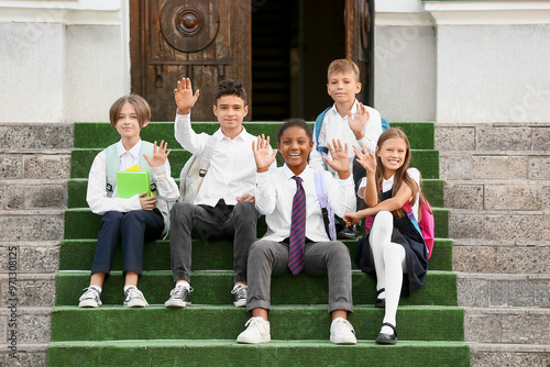 Group of happy pupils wavin...