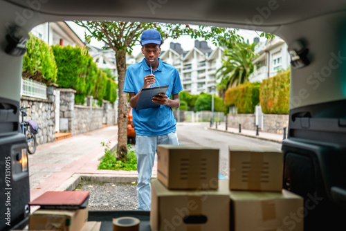 African delivery man doing inventory of the packages to deliver