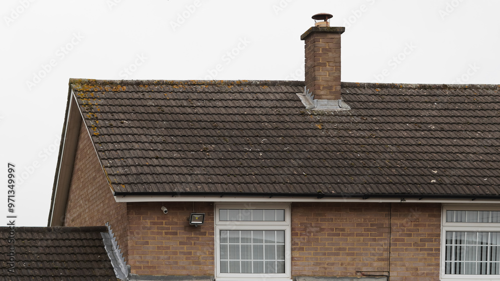 Traditional English house brick roofs, suburban area Traditional English house brick roofs, suburban area