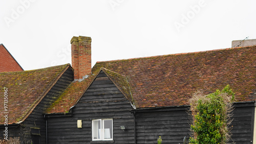 Traditional English house brick roofs, suburban area photo