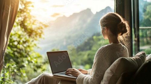 Digital nomad s minimalist workspace  laptop by window with scenic daylight view and clean lines photo