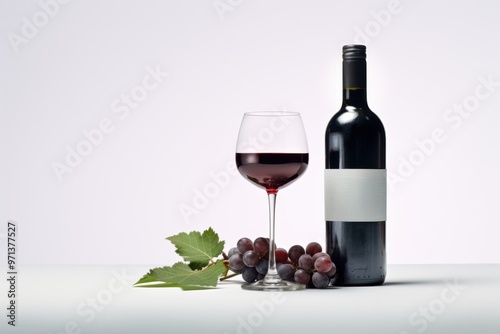 A sophisticated arrangement of a wine bottle, a filled glass, and a cluster of grapes on a pristine white background, exuding elegance and refined taste.