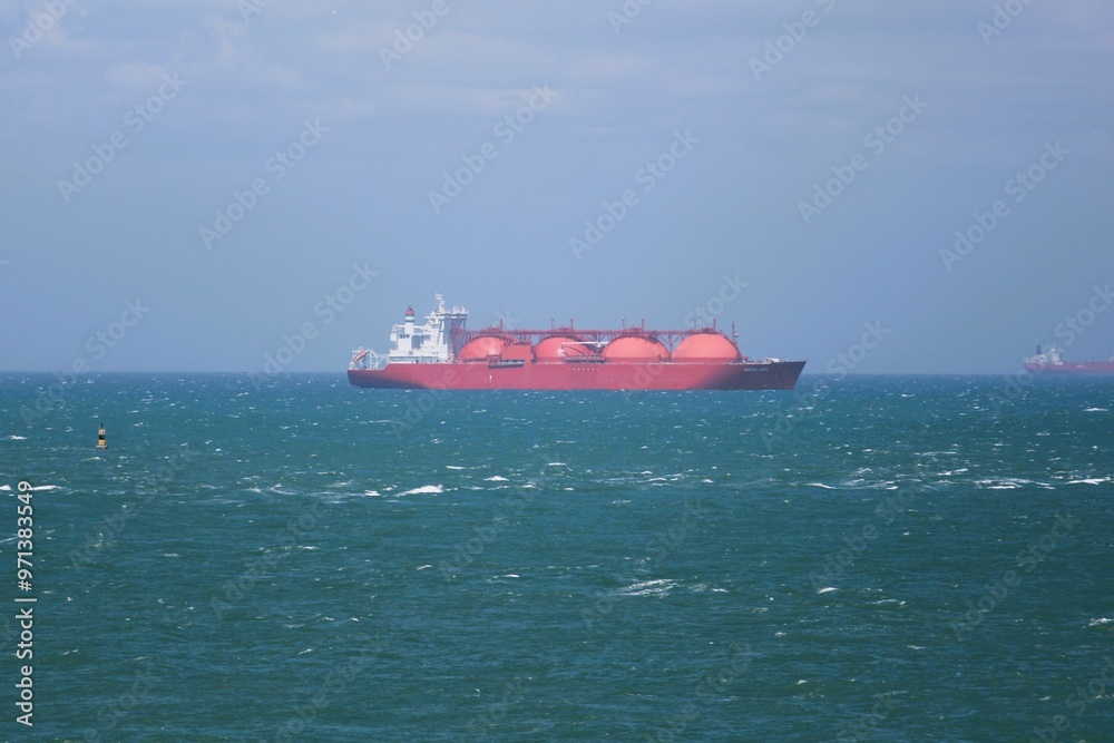 big red tanker on turquoise sea water with blue sky background big red tanker on turquoise sea water with blue sky background
