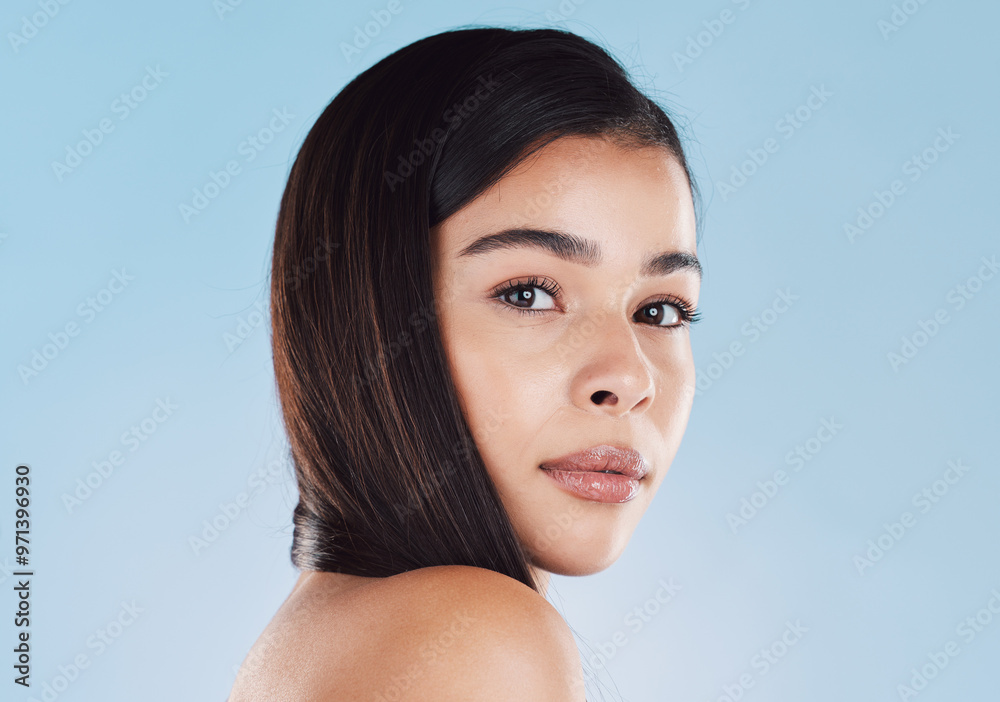 Girl, portrait or serious for beauty in studio with natural skincare, self care glow or dermatology treatment. Model, woman or pride with skin hydration facial or mockup on blue background in Belgium