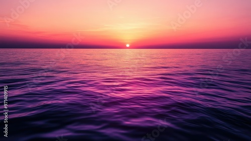 A serene sunset over a calm ocean, showcasing vibrant hues of purple and pink.