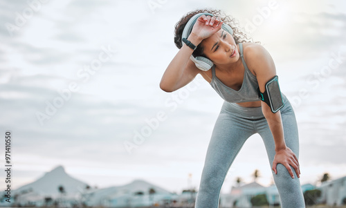 Quadro em tela Fitness, woman and tired runner with headphones outdoor for exercise break, breathing and intense performance