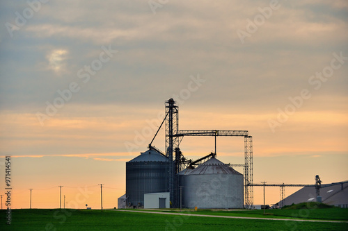 An agricultural cooperative offers a foreground for a summer sunsert in north central Illinois. The area is dominated by small communities and agriculture in the heart of the Midwestern United States