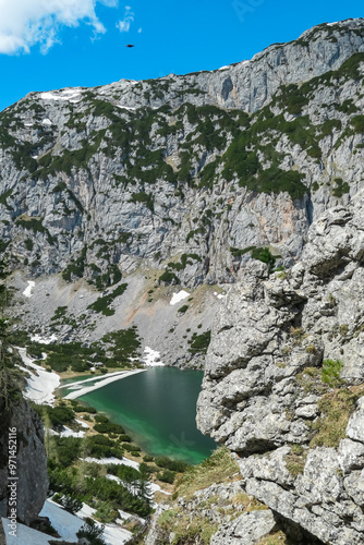 Aerial view of serene alpine lake Hölltalsee (Silberkarsee) surrounded by majestic snow-capped landscape in Schladming, Styria, Austria. Hiking trail in Austrian Alps in spring. Schladminger Tauern photo