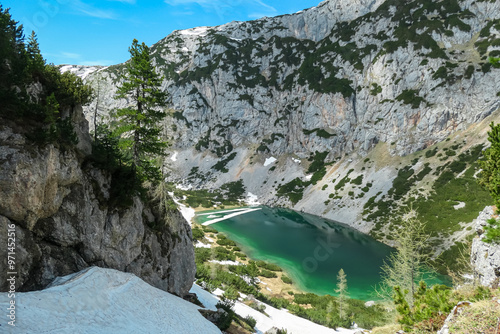 Aerial view of serene alpine lake Hölltalsee (Silberkarsee) surrounded by majestic snow-capped landscape in Schladming, Styria, Austria. Hiking trail in Austrian Alps in spring. Schladminger Tauern photo