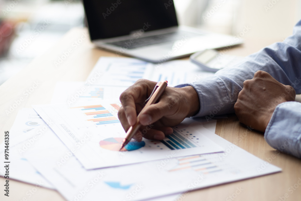 A businessman is analyzing his company's profits with a success graph that he has plotted. A businessman is analyzing his company's profits with a success graph that he has plotted.