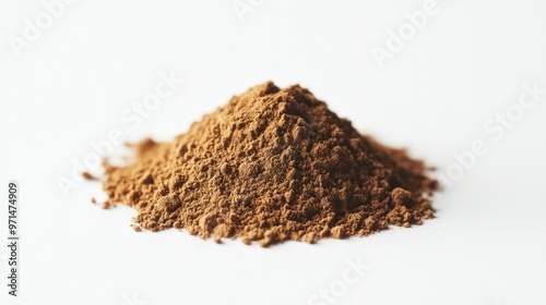 A neat pile of roasted hojicha powder set against a simple white background, emphasizing its natural tea texture