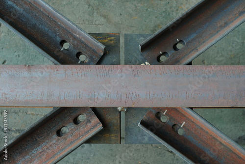 Connecting metal beams with a crosspiece with oval holes. Strength and stability of structures, as well as to compensate for possible deformations or thermal expansion of the metal. photo