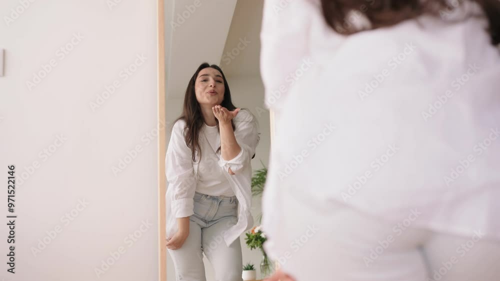 A plus size young woman is dancing joyfully in front of a mirror, showcasing self-love and radiating positivity with her spirited demeanor. A plus size young woman is dancing joyfully in front of a mirror, showcasing self-love and radiating positivity with her spirited demeanor.