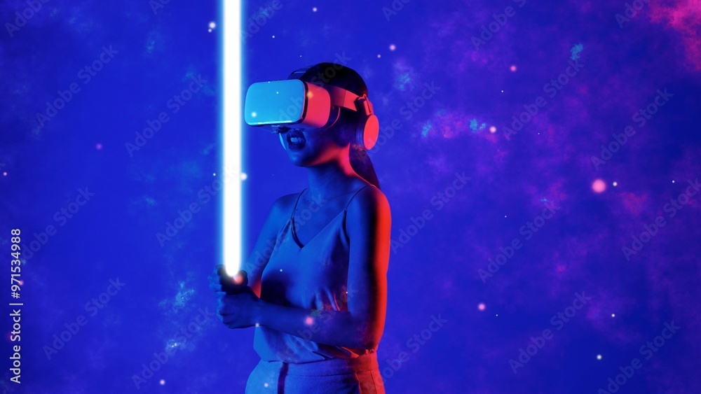 Woman player using VR transfer to fantastic metaverse fencing game looking material holding sword laser fantasy gaming space with lighting bokeh on blue smoke meta 3D cyberspace world. Hallucination. Woman player using VR transfer to fantastic metaverse fencing game looking material holding sword laser fantasy gaming space with lighting bokeh on blue smoke meta 3D cyberspace world. Hallucination.