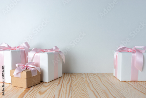 Creative composition with Christmas gift boxes on wooden table. Minimal Christmas or New Year concept.