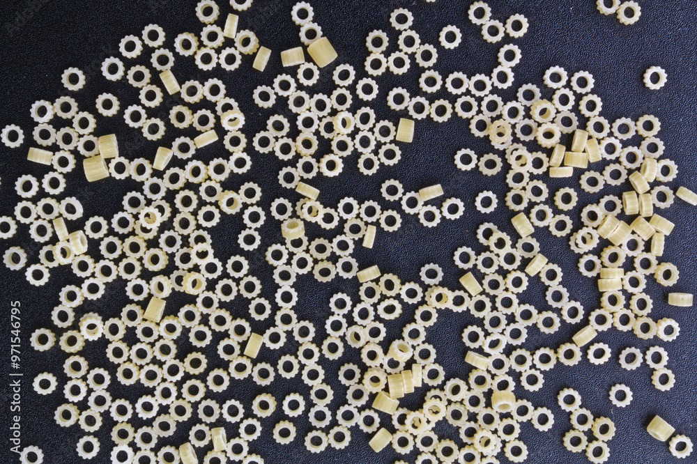 High-resolution image showcasing an artistic arrangement of uncooked pasta on a dark background. Ideal for culinary themes and creative projects. Perfect for backgrounds, textures, and food art. High-resolution image showcasing an artistic arrangement of uncooked pasta on a dark background. Ideal for culinary themes and creative projects. Perfect for backgrounds, textures, and food art.