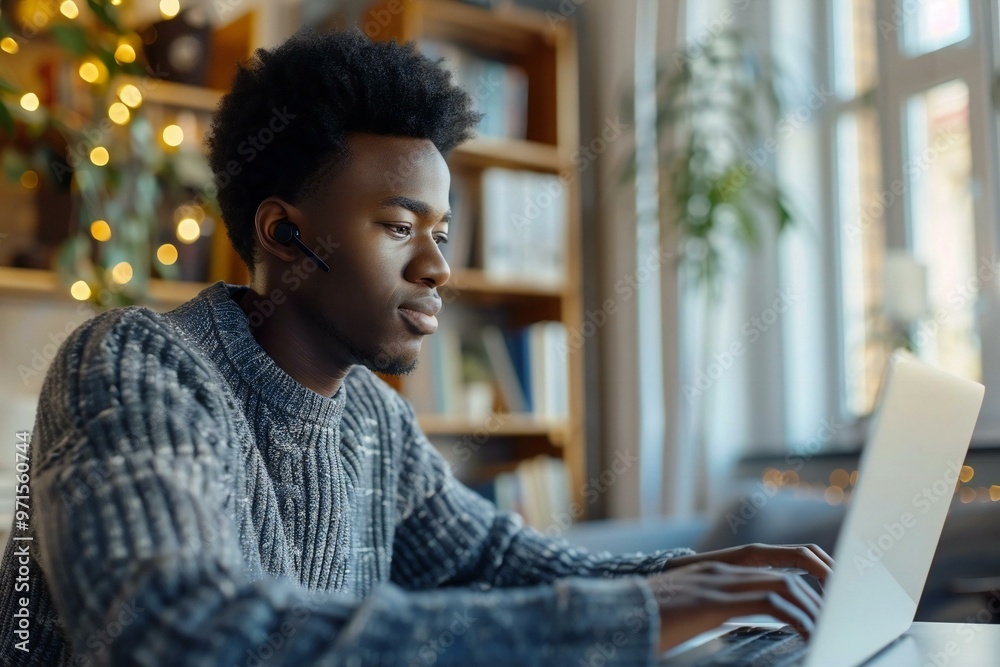 African young man working from home, having a video conference call with his diverse team on his laptop. Happy and managing successfully remotely. African young man working from home, having a video conference call with his diverse team on his laptop. Happy and managing successfully remotely.