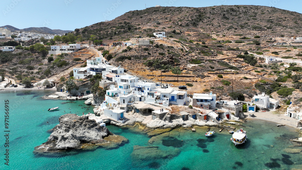 Aerial drone photo of picturesque seaside area and bay of Goupa - Karra with colourful boat houses and elephant rock a perfect place to swim, Kimolos island, Cyclades, Greece Aerial drone photo of picturesque seaside area and bay of Goupa - Karra with colourful boat houses and elephant rock a perfect place to swim, Kimolos island, Cyclades, Greece