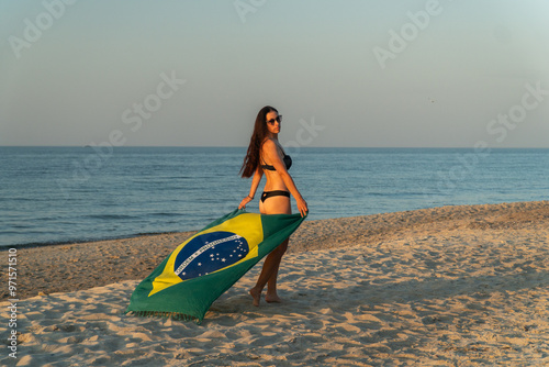 brazilian flag on the ocean shore, taking photo, seashore, brazilian flag at sunset, girl posing, woman holding brazilian flag, woman running with flag, photo