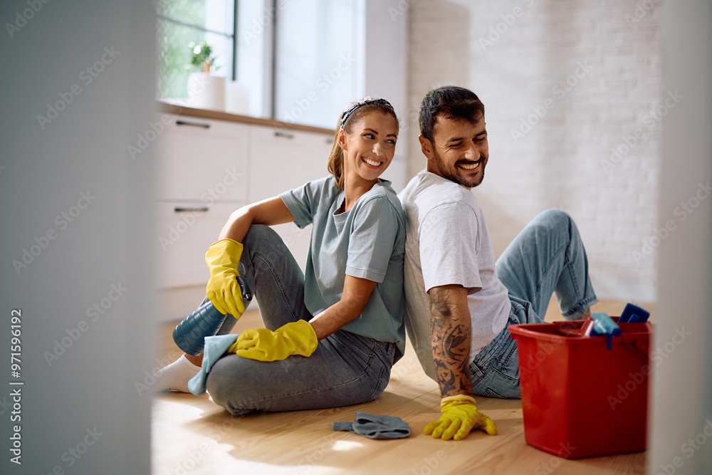 Obraz premium Young happy couple relaxing after doing housework together.