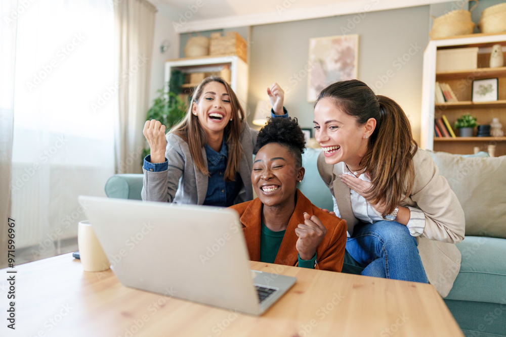 Joyful Friends Sharing Laptop Moment in Home Setting Joyful Friends Sharing Laptop Moment in Home Setting